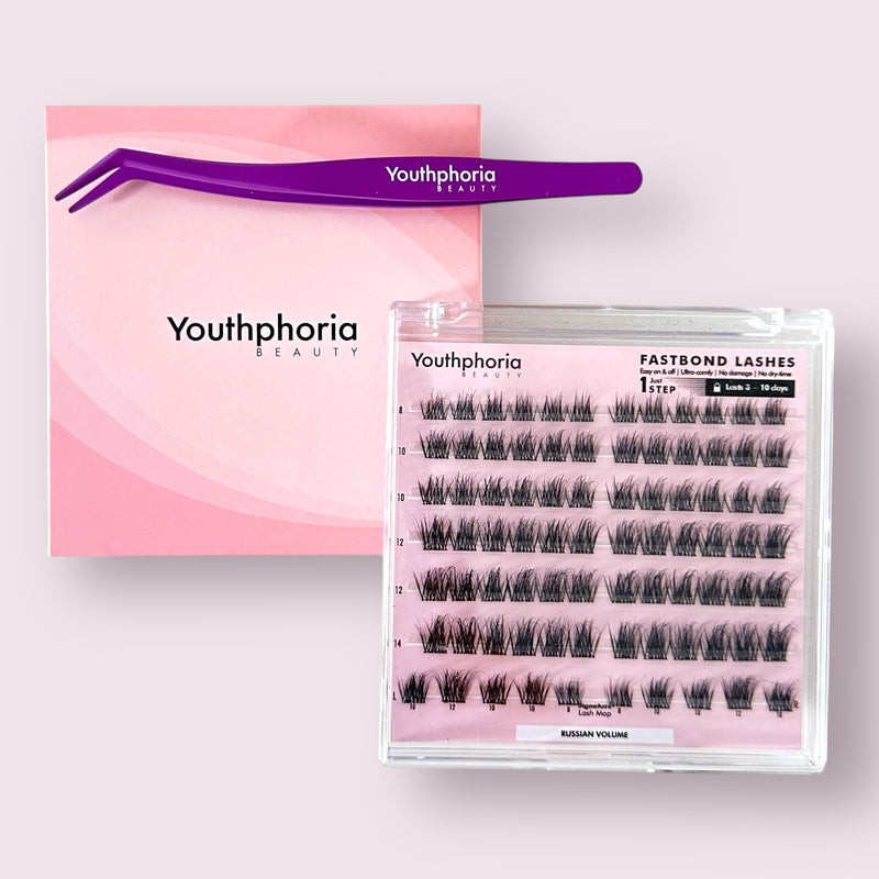 Eyelash packaging with pink box, clear case, and purple applicator on a light pink background.